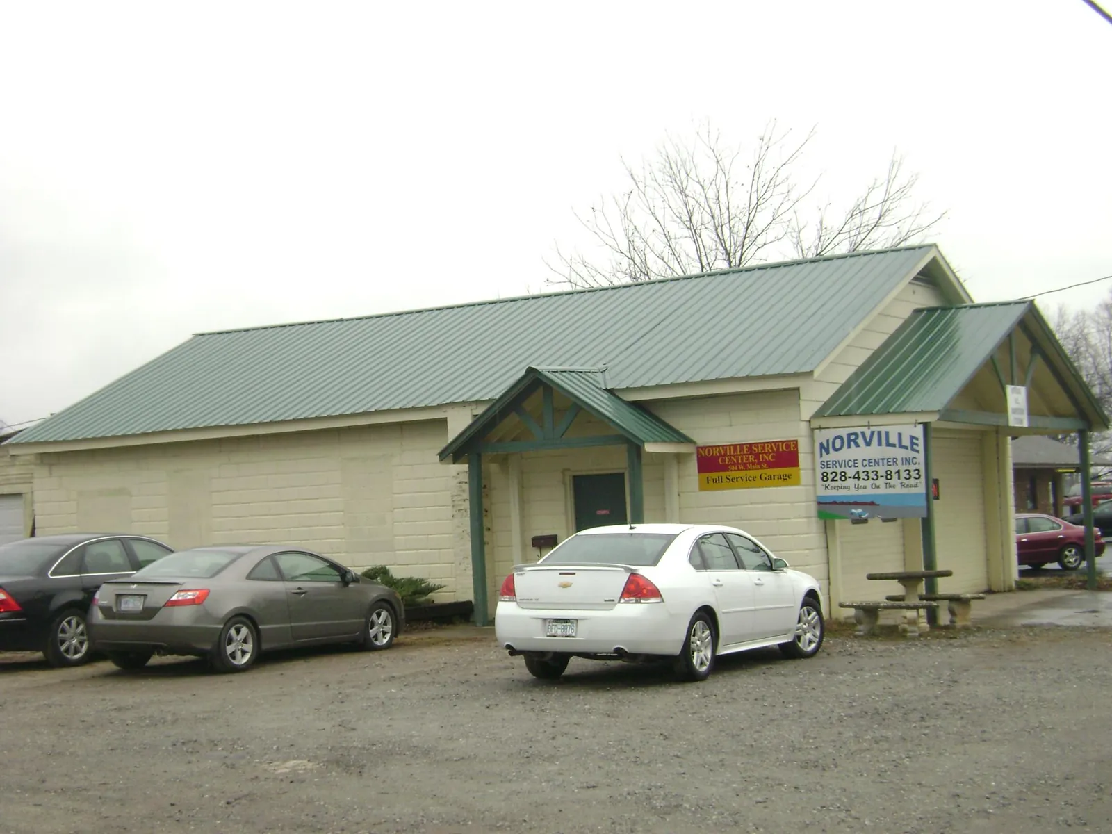 Green metal roof on a service garage with a covered entry in Cheshire
