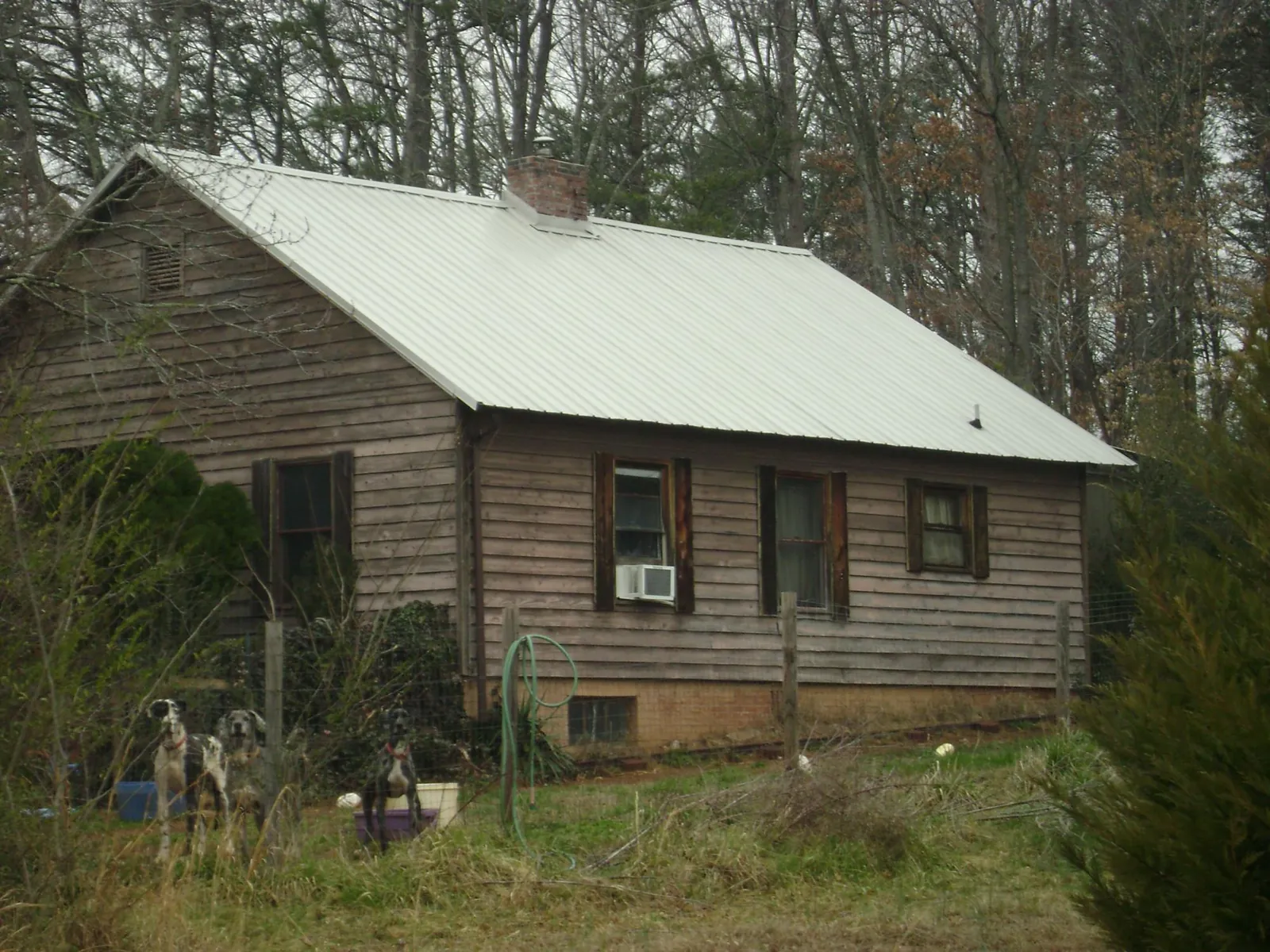White metal roof on an old wood sided farmhouse, from a Metal Roof Installation job in Cheshire
